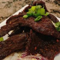 Beef Jerk · Marinated and fried served with a spicy dipping sauce.