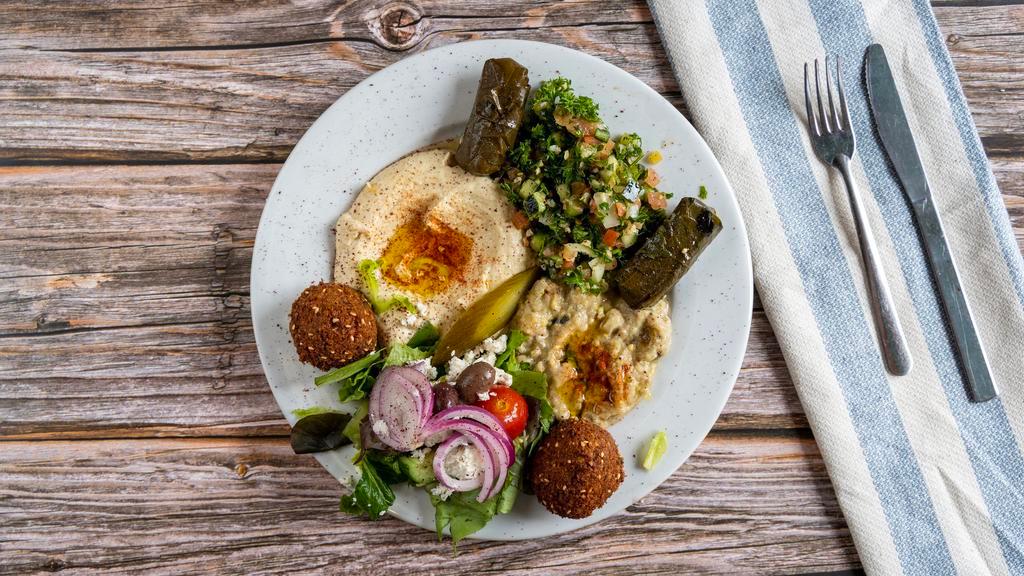 Mediterranean Plates · Served with hummus, tabouli, babaghanous, dolmas and two falafels.