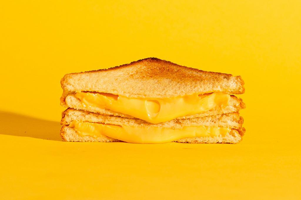 Grilled Cheese · Melted american and cheddar cheese on buttery toasted bread.