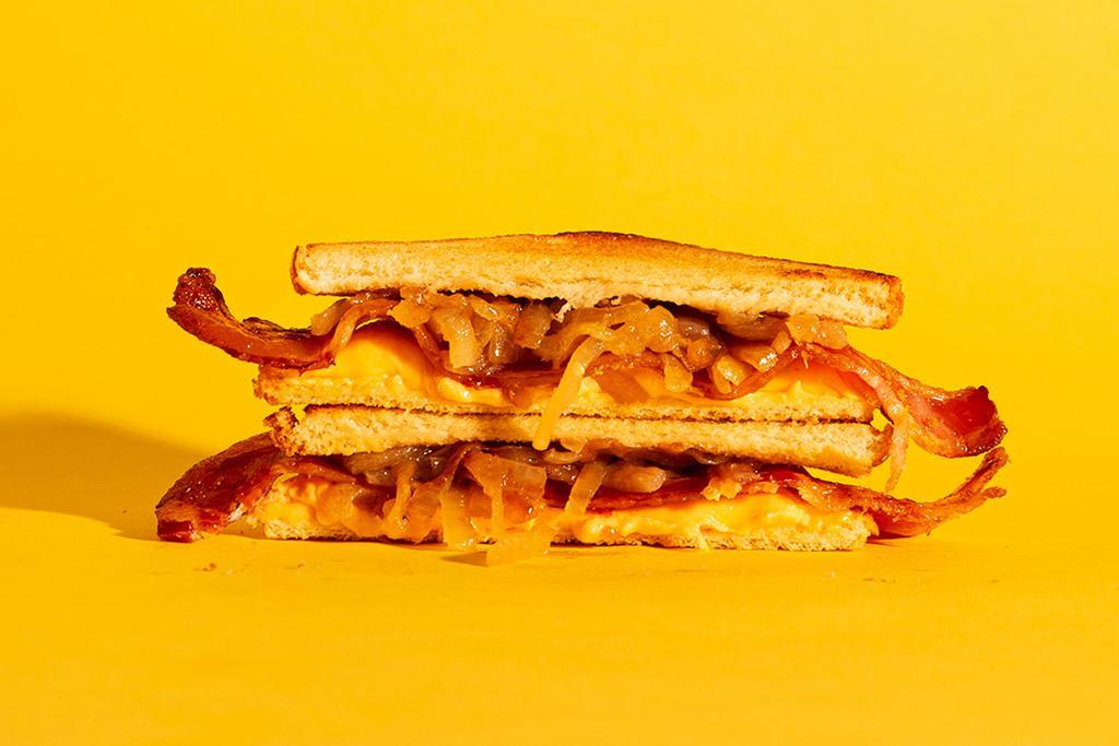 Bacon Grilled Cheese · Melted american and cheddar cheese, crispy bacon, and caramelized onions on buttery toasted bread.
