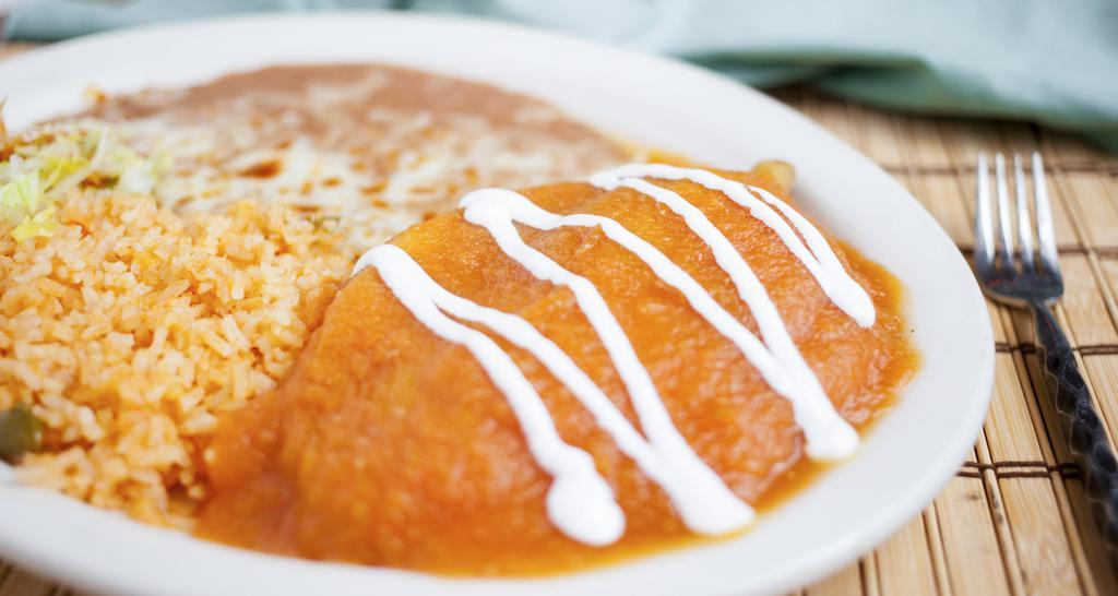 Spicy Chili Pasillas · A fresh chile pasilla filled with queso fresco, covered with egg batter and topped with juicy sauce. Served with rice beans.