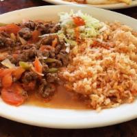 Steak or Chicken Ranchero · Slices of skirt steak or chicken simmered with our own special sauce with bell peppers, onio...