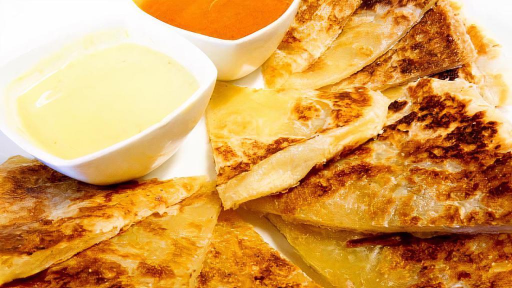 Roti · Pan fried Thai bread and served with curry and peanut sauce.