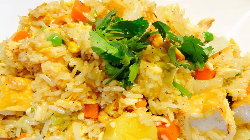 Pineapple Fried Rice · Stir fried rice, pineapple, raisin, cashew nut, egg, green pea, carrot, curry powder, yellow and green onion.