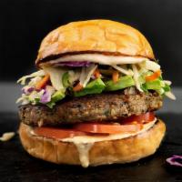 VEGGIE BURGER · Homemade veggie burger, avocado, savory jalapeño slaw, tomato, smoked aioli, and split sauce.