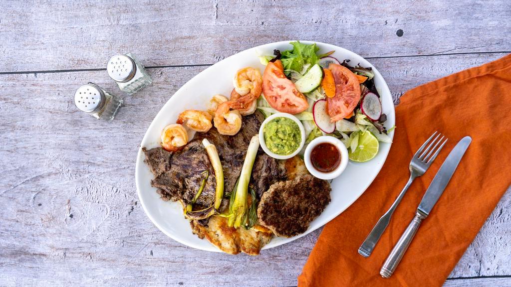 Mar y Tierra · Beef steak, shrimp, grilled chicken, chorizo, rice, beans, guacamole, fresh salad and grilled onions.