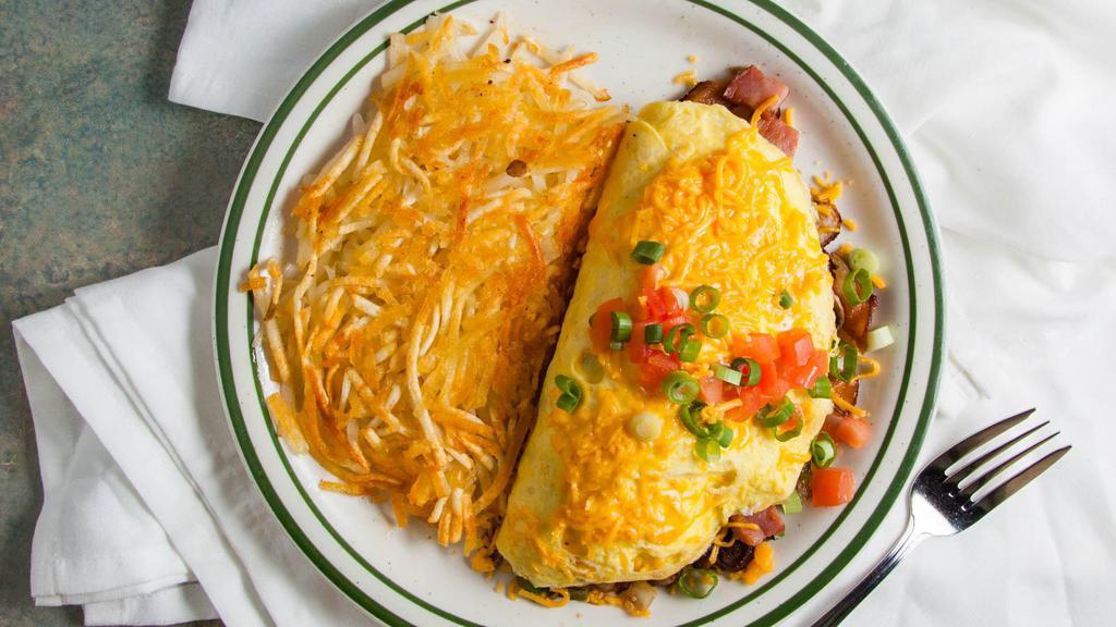Meat Lovers Omelet · Diced ham, bacon, sausage, onions, mushrooms, and bell peppers topped with shredded cheddar cheese, green onions and diced tomatoes. 1369-1931 cal.