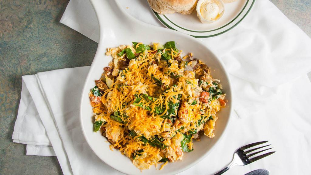 Veggie Skillet · Fresh mushrooms, spinach, tomatoes & zucchini scrambled into two fresh eggs, topped with cheddar cheese, and served on top of potatoes.