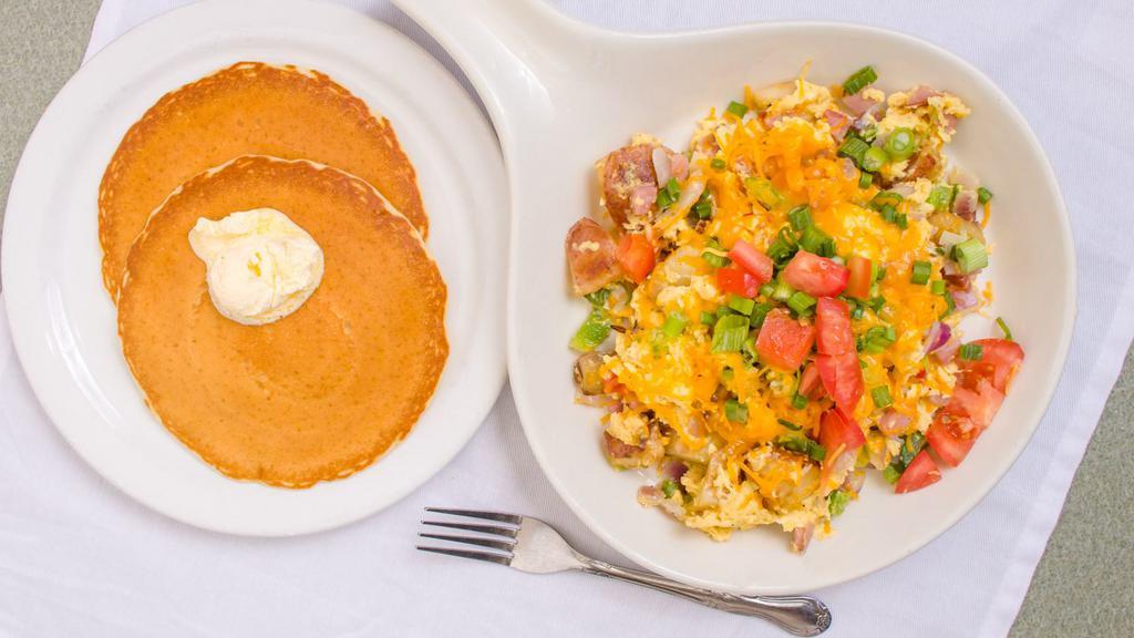 The Farmers Scramble · Diced ham, scrambled eggs, bell pepper, onion, potatoes and cheddar cheese. Topped with tomato and green onion. 895-1530 cal.