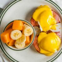Eggs Benedict · Two poached eggs over  sliced ham on a grilled English muffin and topped with hollandaise sa...