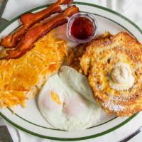 Cinnamon Roll French Toast · Two slices of cinnamon roll battered and grilled, served with two eggs and two bacon slices ...