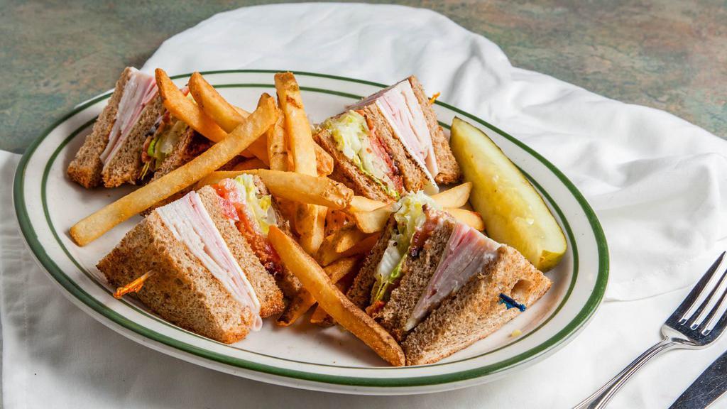 Club Sandwich · Turkey, ham, bacon, lettuce and tomatoes stacked on toasted wheat.