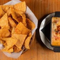 QUESO FUNDIDO * · Our signature queso made with Oaxaca cheese. Topped with roasted pasilla peppers, and served...