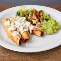 FLAUTAS * · Three crunchy rolled tacos served with Mexican crema, guacamole, and queso fresco.
