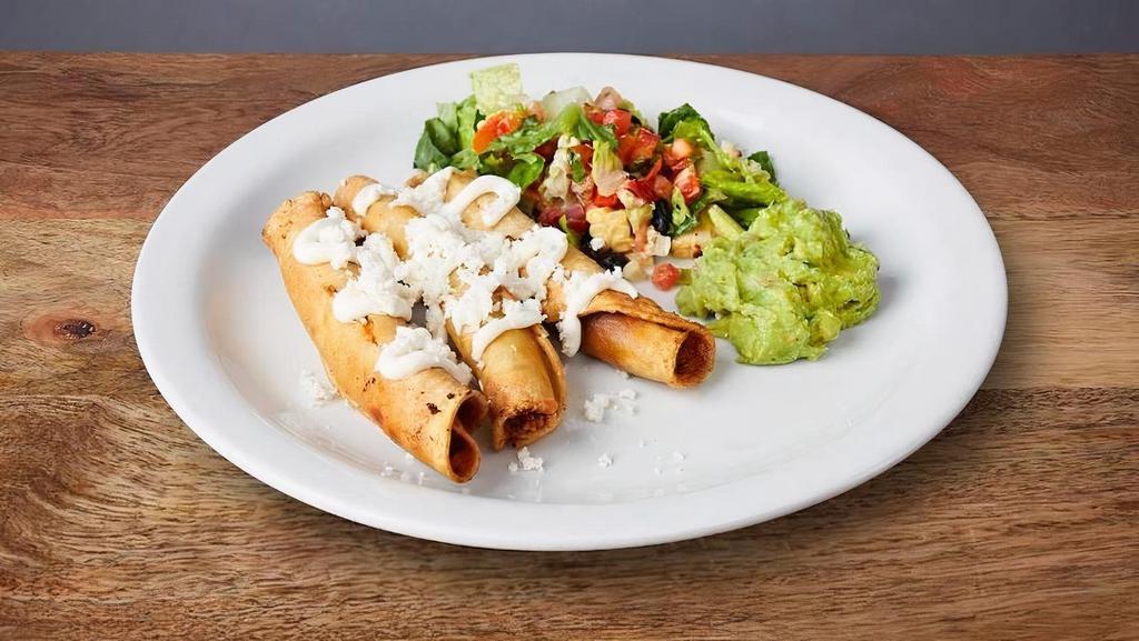 FLAUTAS * · Three crunchy rolled tacos served with Mexican crema, guacamole, and queso fresco.