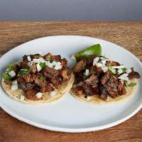 KID STREET TACOS * · Authentic Mexican tacos topped with cilantro & onions on small corn tortillas - choose two o...