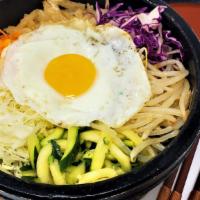 Hot Stone Pot · Rice and crispy rice topped with heated up, assorted veggies, and a fried egg.