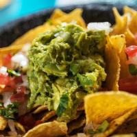 Super Nachos · Delicious Nacho chips topped with customer's choice of meat, beans, cheese, guacamole, sour ...