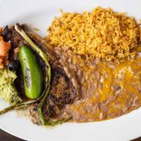 Carne Asada · Grilled new york steak with roasted tomato sauce onion jalapeño and tortillas