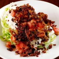 Wedge Salad · Iceberg wedge, tomato, bacon, and blue cheese dressing.