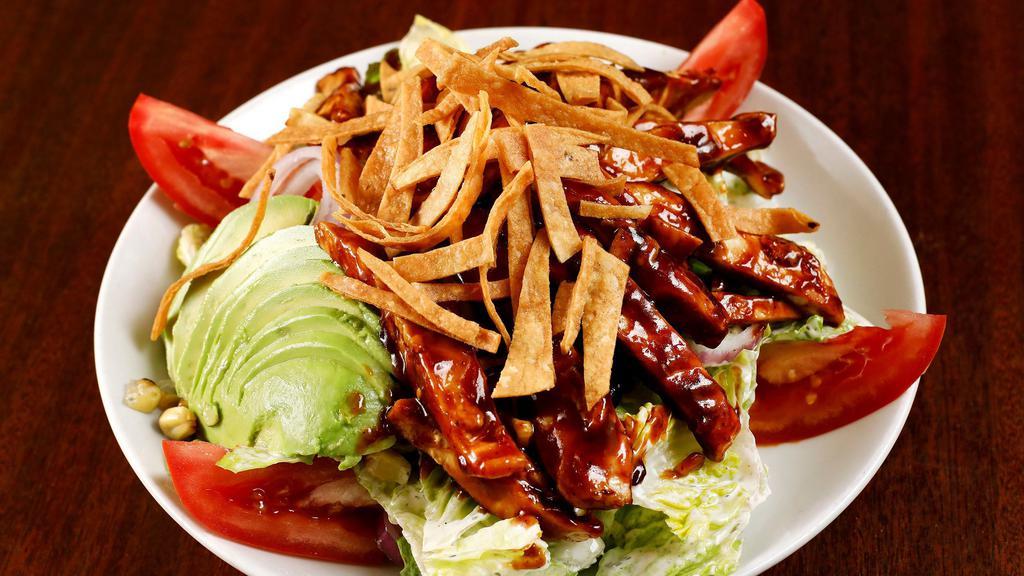 BBQ Chicken Salad · Romaine, BBQ chicken, avocado, red onion, tomato, grilled corn, black beans, and tortilla strips with ranch.