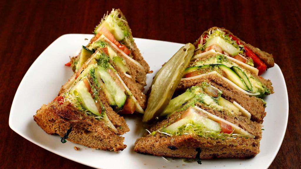 Veggie Club · Grilled red bell pepper, zucchini, sun-dried tomato pesto, tomato, cucumber, avocado, Swiss cheese, and sprouts on whole wheat toast.