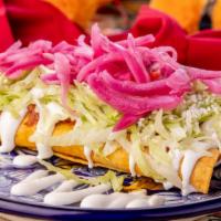 Flautas · Cochinita pibil, red onions with habanero, lettuce, sour cream, and cheese.