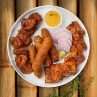 Tandoori Feast Platter · An assortment of chicken tikka, lamb seekh kabab and fish tikka.