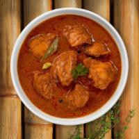 Curry Me Away · Boneless cubes of chicken cooked in a tomato based curry.