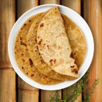 Paratha · Unleavened layered wheat bread topped with melted butter.