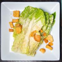 Caesar · Romaine lettuce, shaved parmiggiano, croutons, caesar dressing.
