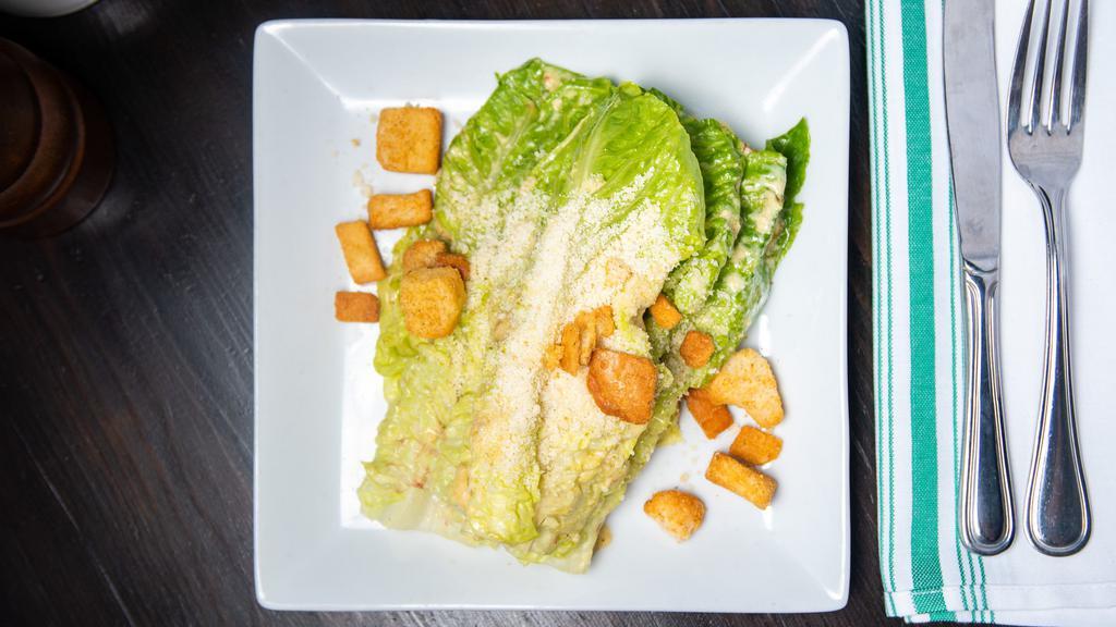 Caesar · Romaine lettuce, shaved parmiggiano, croutons, caesar dressing.