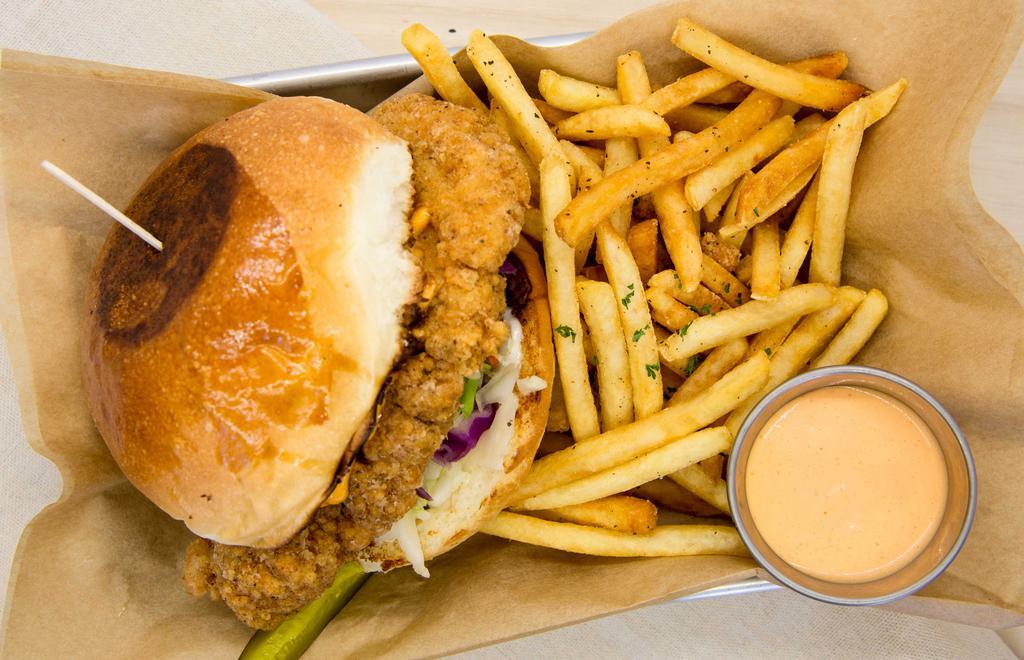 Fried Chicken Sandwich · Served with fries. Fried chicken thigh, coleslaw, sweet passion bun, mayonnaise, and spicy aioli or thousand island.