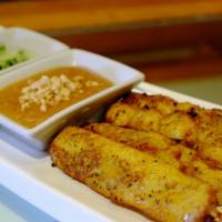 A1. Chicken Satay · Skewered marinated strips of grilled chicken breast, served with cucumber salad and peanut s...