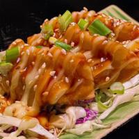 A9. Pot Sticker · Vegetable and chicken dumplings topped with chef's sauce and sesame seeds.
