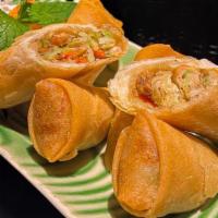 A4. Veggie Spring Rolls · Golden fried veggie rolls filled with a mixture of vegetables, tofu, and bean thread noodles...