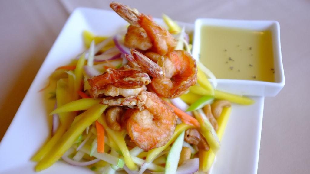 SA7. Mango Salad (Seasonal) · Green apples, green mangos, carrots, red onions, cashew nuts, and prawns, served with house lime dressing.