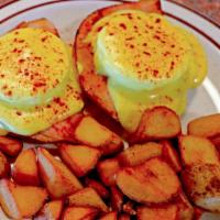 Eggs Benedict · Two eggs and two slices of ham over a halved and grilled English muffin, topped with a delic...