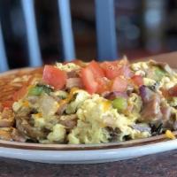 Country Scramble · Three eggs with diced ham, mushrooms, peppers, and onions, topped with tomatoes and cheddar ...