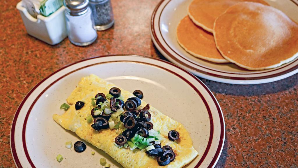 BMP Omelette · Wake up your taste buds with Bacon, Mushrooms, and Pepper jack cheese. Garnished with black olives and green onions.