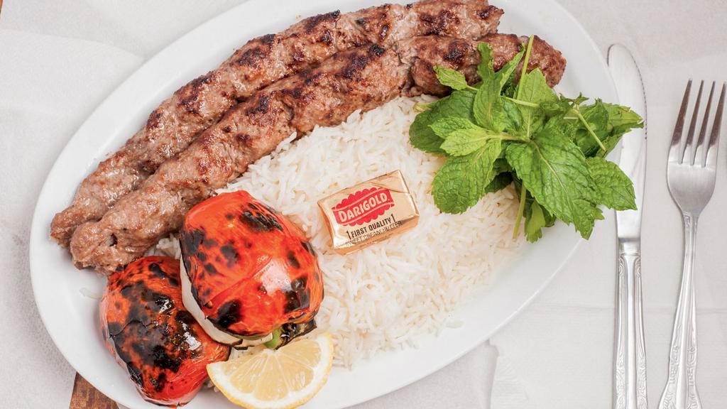 37. Beef Kabob Over Rice · Two skewer over basmati rice and BBQ tomato.
