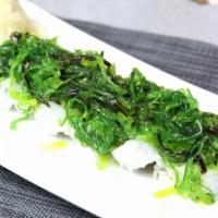 Green Island Roll · Salmon, tuna, hamachi, avocado, cucumber topped with seaweed salad.