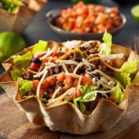 Taco Salad · Fresh romaine tossed with rice, beans, fresh salsa, guacamole, cheeses and sour cream with a...
