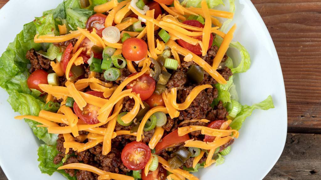Steak Taco Salad · Delectable steak salad featuring romaine, rice, beans, fresh salsa, guacamole, cheeses and sour cream. Served with a crisp tortilla shell.