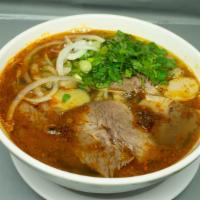 B66. Lemongrass & Spicy Vermicelli Soup Bun Bo Hue · Traditional spicy Vietnamese vermicelli noodle soup with pork blood, brisket, pork cake.