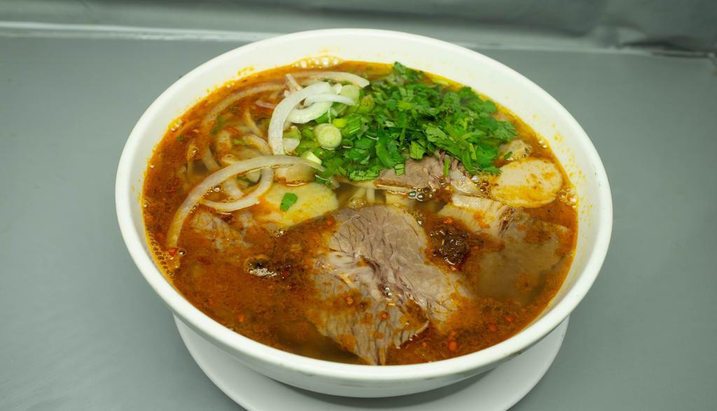 B66. Lemongrass & Spicy Vermicelli Soup Bun Bo Hue · Traditional spicy Vietnamese vermicelli noodle soup with pork blood, brisket, pork cake.