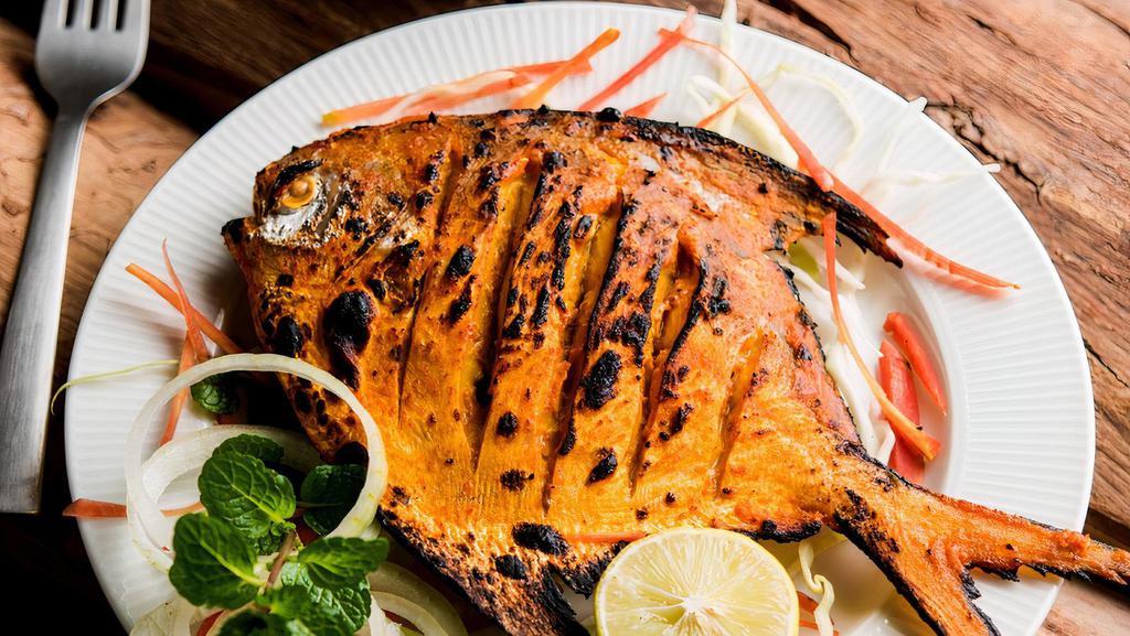 Tandoori Fish · Pomfret Fish whole marinated with exotic house special spices - cooked in Tandoor. Most popular and spicy.