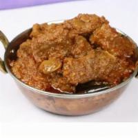 Kadai Goat · Goat cooked with bell peppers, onions, and tomatoes with a touch of cream and onion gravy.