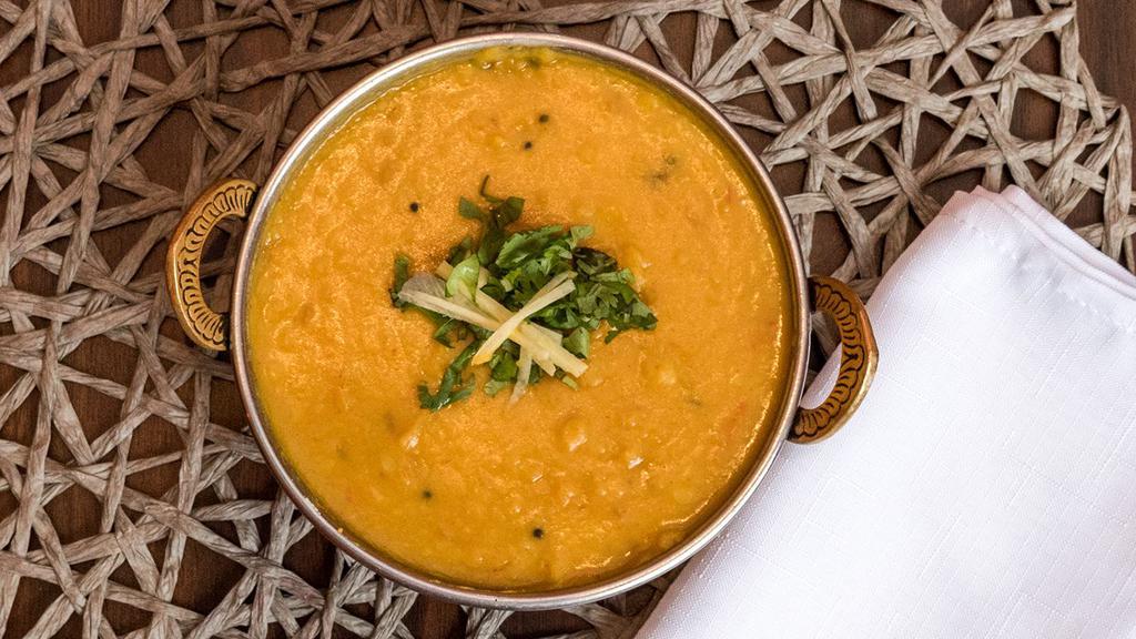 Tadka Dal · Boiled yellow lentil tempered with cumin, mustard, garlic and curry leaves. Veggie.