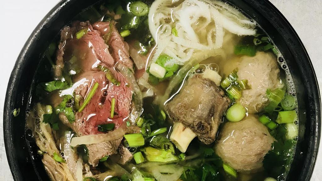 73. Pho Bo Dac Biet · Combo Pho - rare filet mignon, tendon, well done flank, fat brisket, tripe, and oxtail.